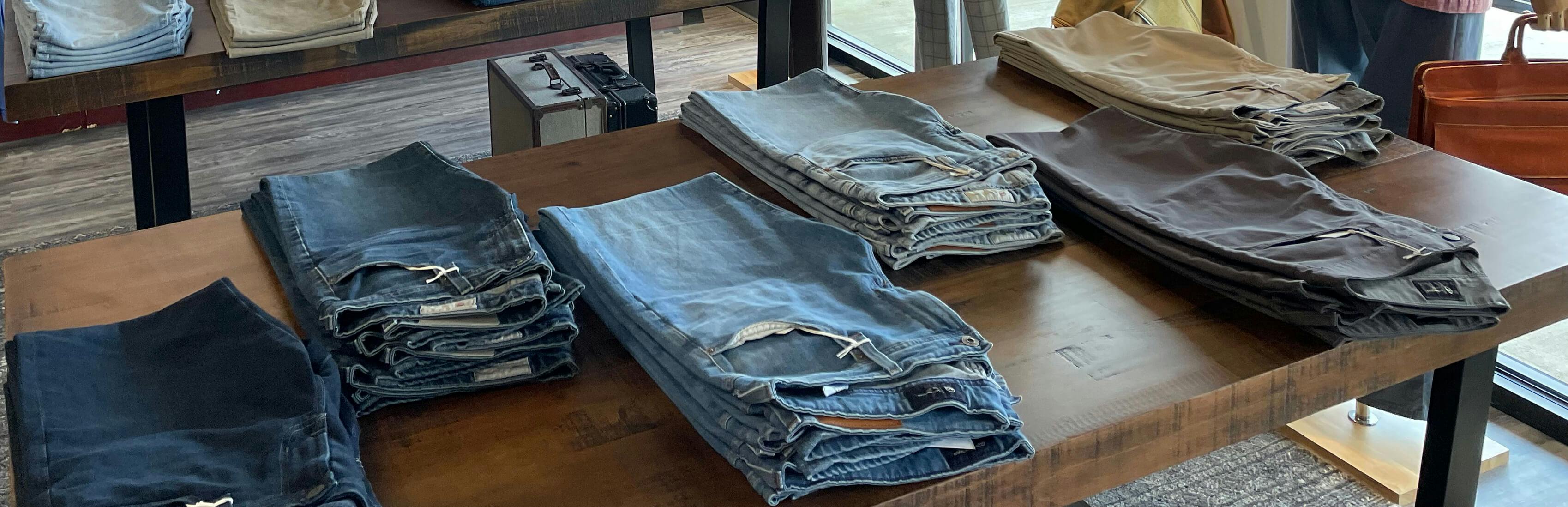 Image of a stylish and diverse collection of jeans showcased in JwR's store.