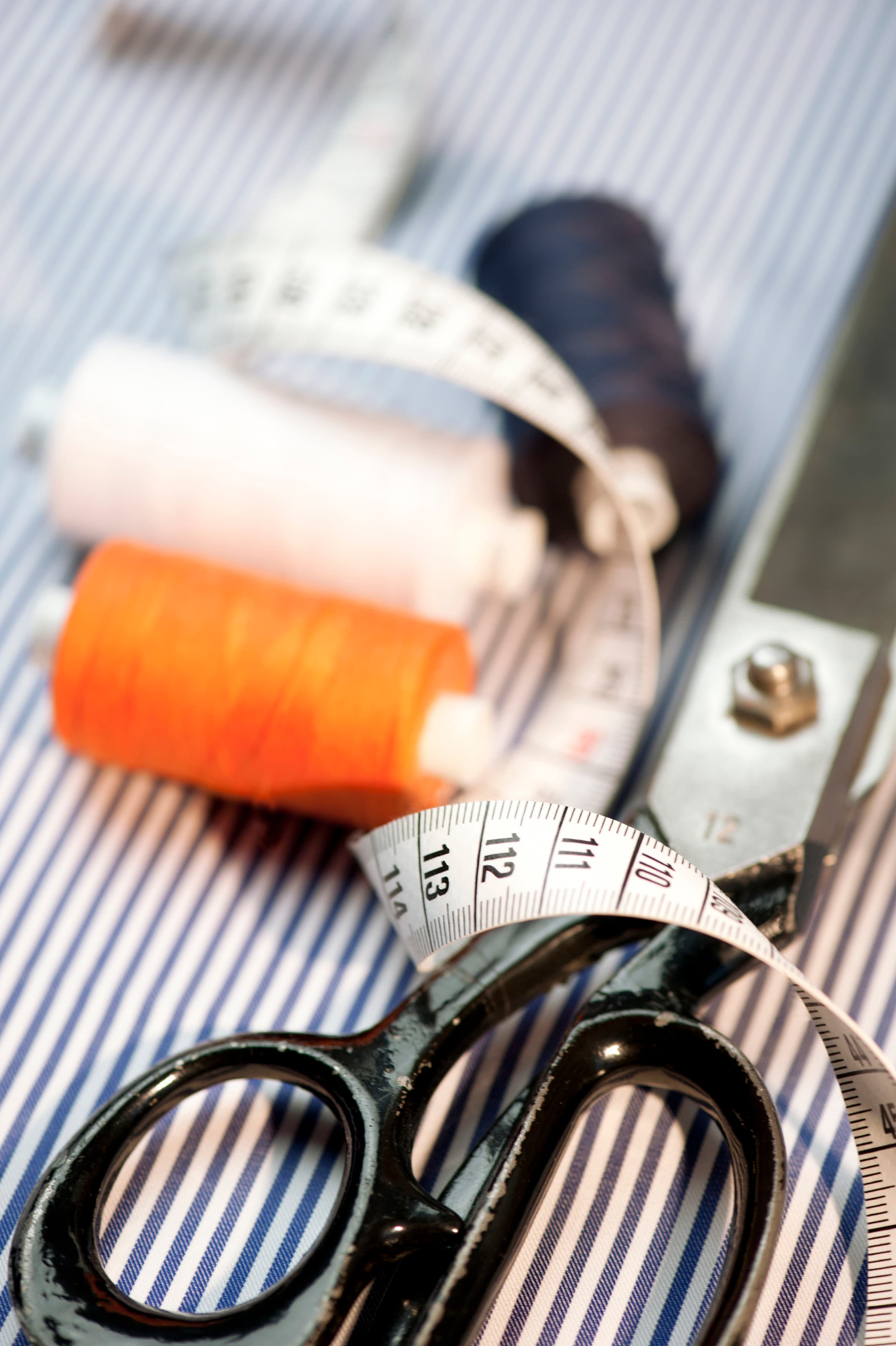 Natural leather mouse pad on white desk next to porcelain mug and keyboard.