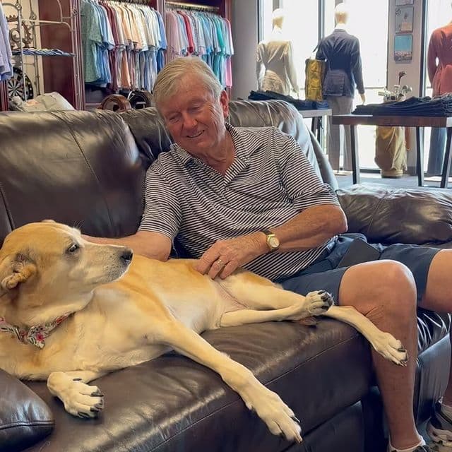 Person placing task list card into walnut card holder next to felt carrying case on leather desk pad.
